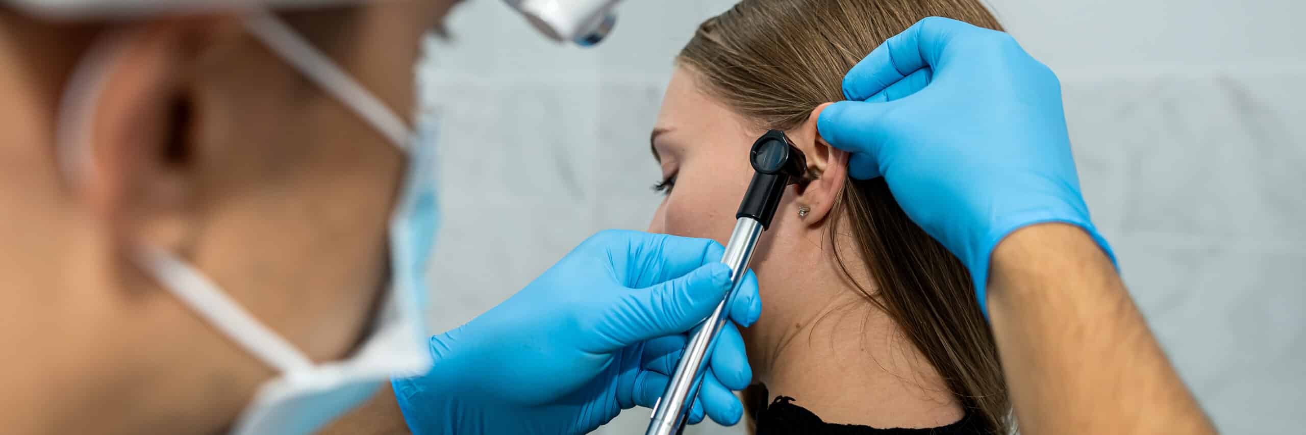 Male doctor or ENT specialist examining the ear with an endoscope